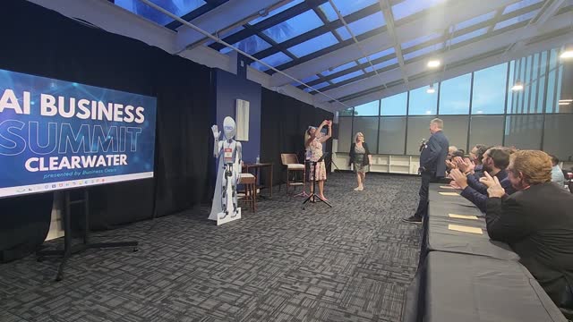 Alissa Mastropietro speaking on stage at a business event